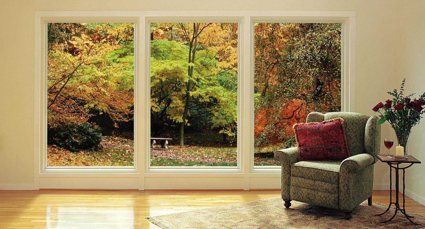 Three large pane windows look out to the backyard