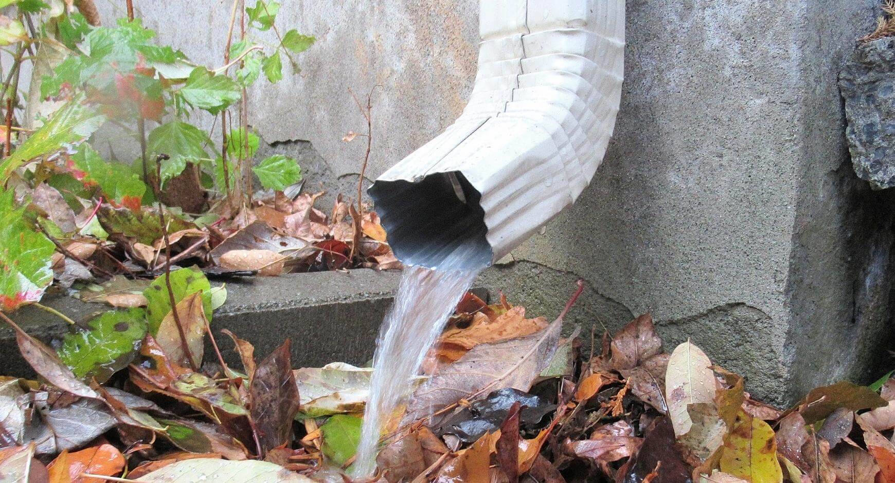 water gushing out of a gutter