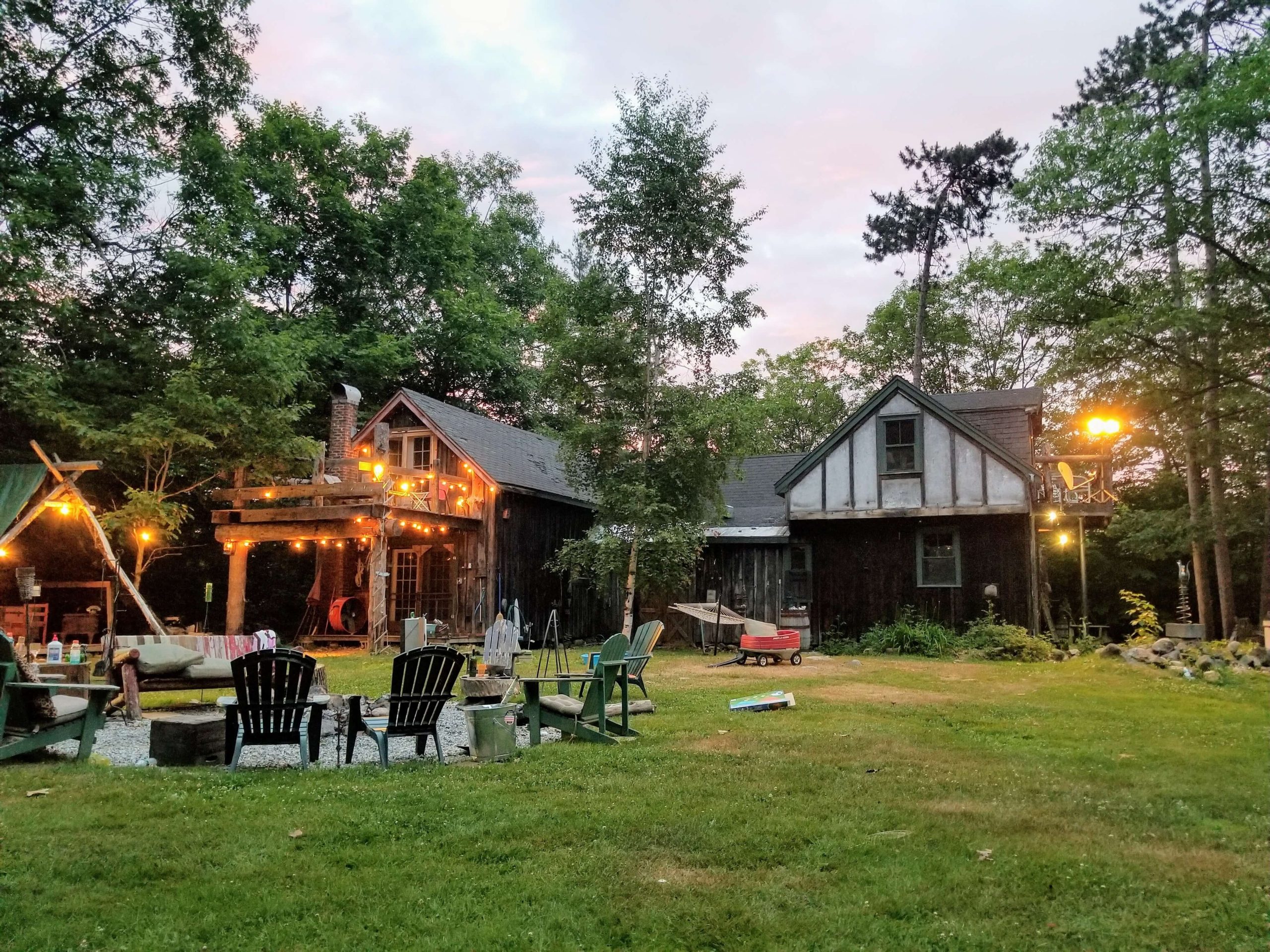 backyard with a patio and a deck with string lights