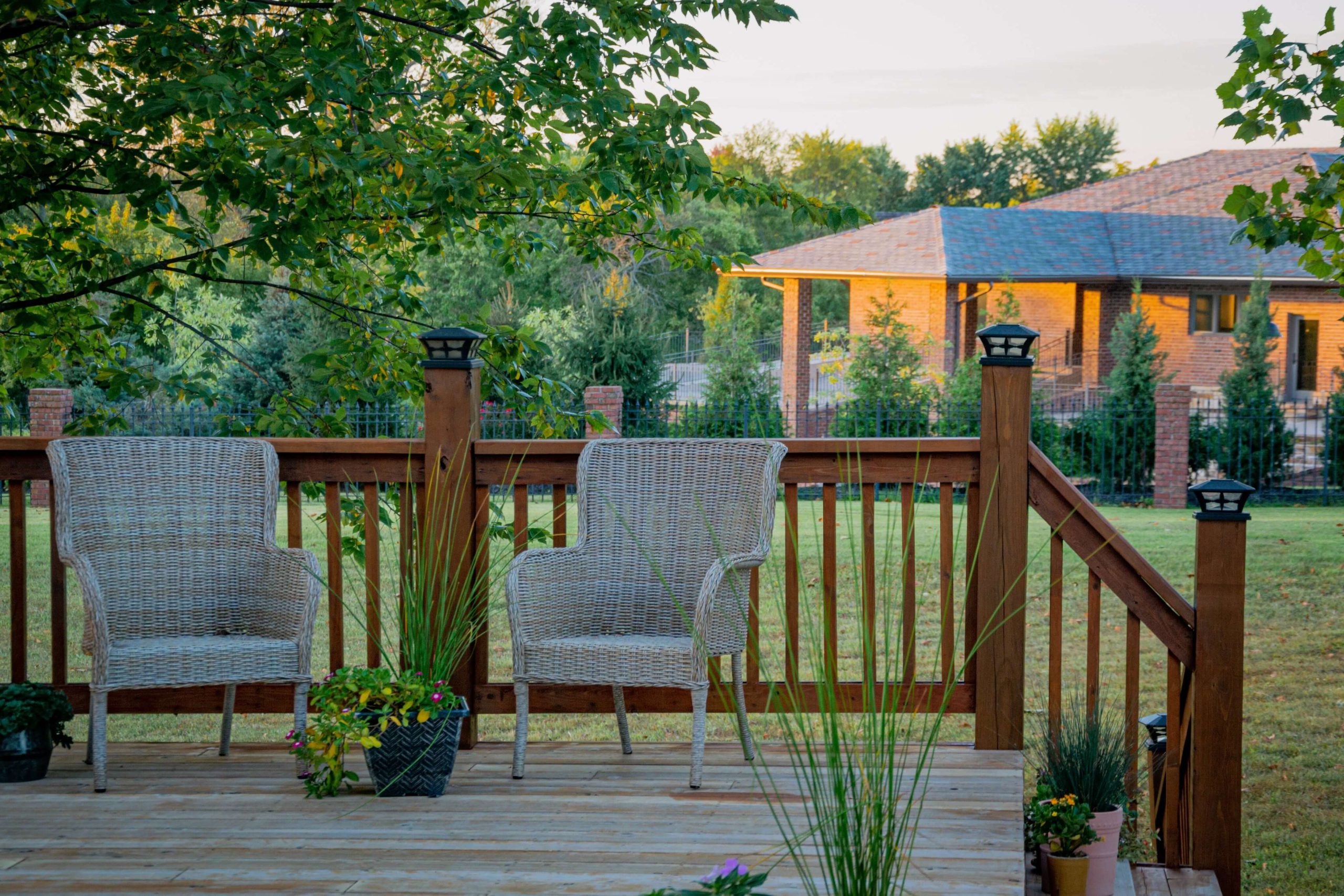 two chairs on a deck with a railing