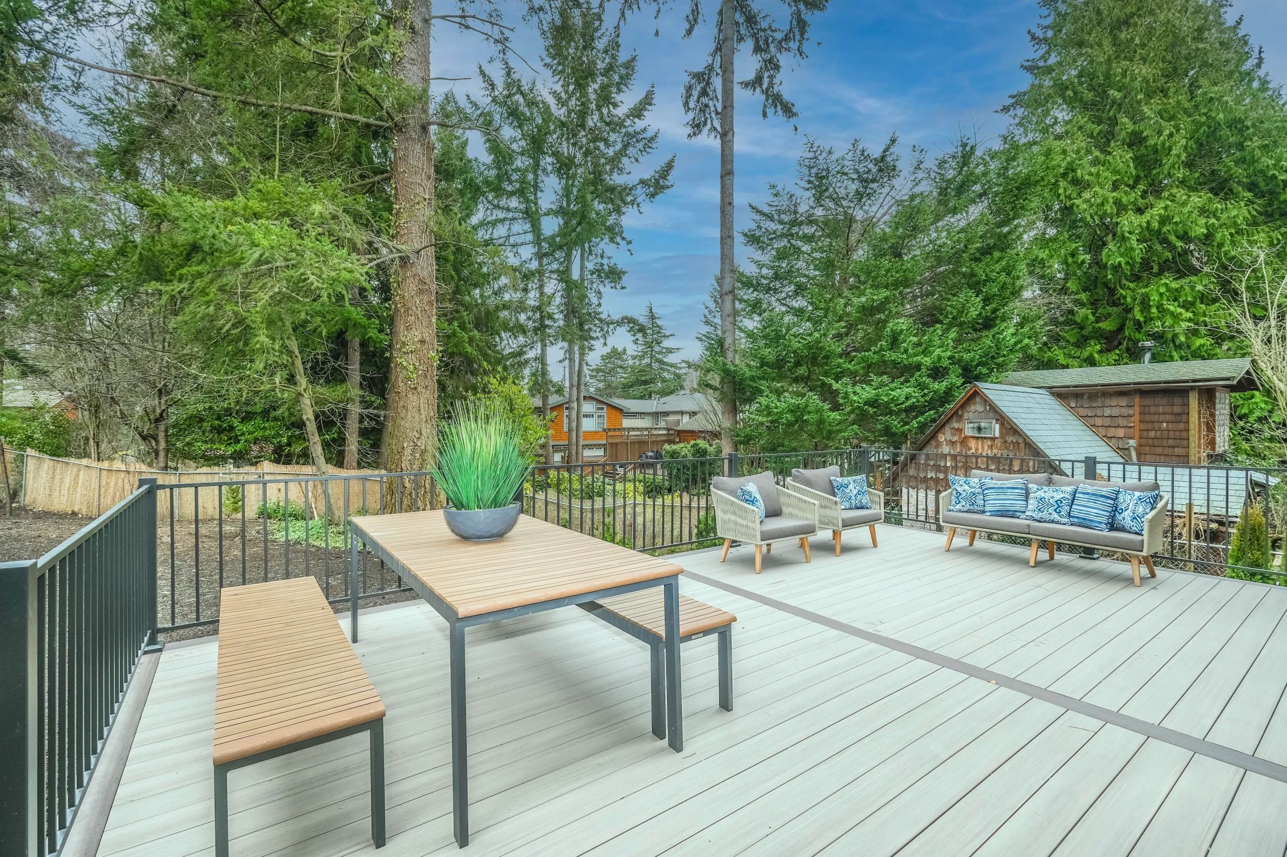 deck with a table, chairs, and a bench