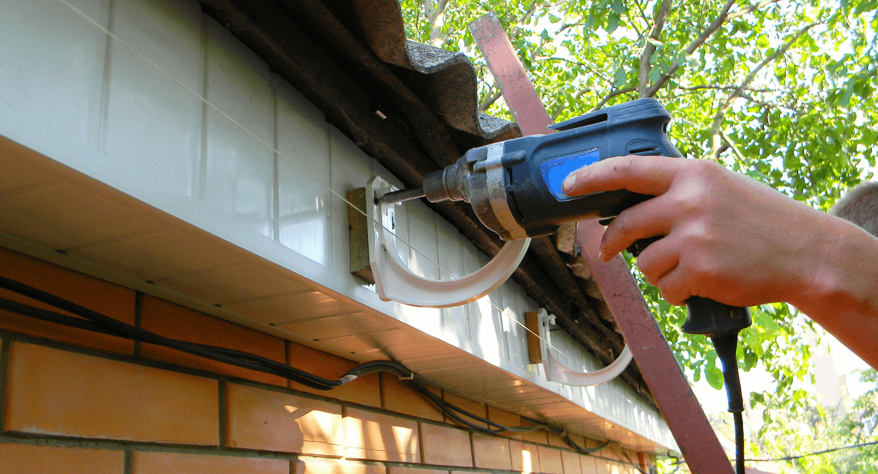 Image of an individual hanging gutters