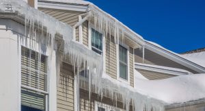 Ice dams and icicles on a house roof