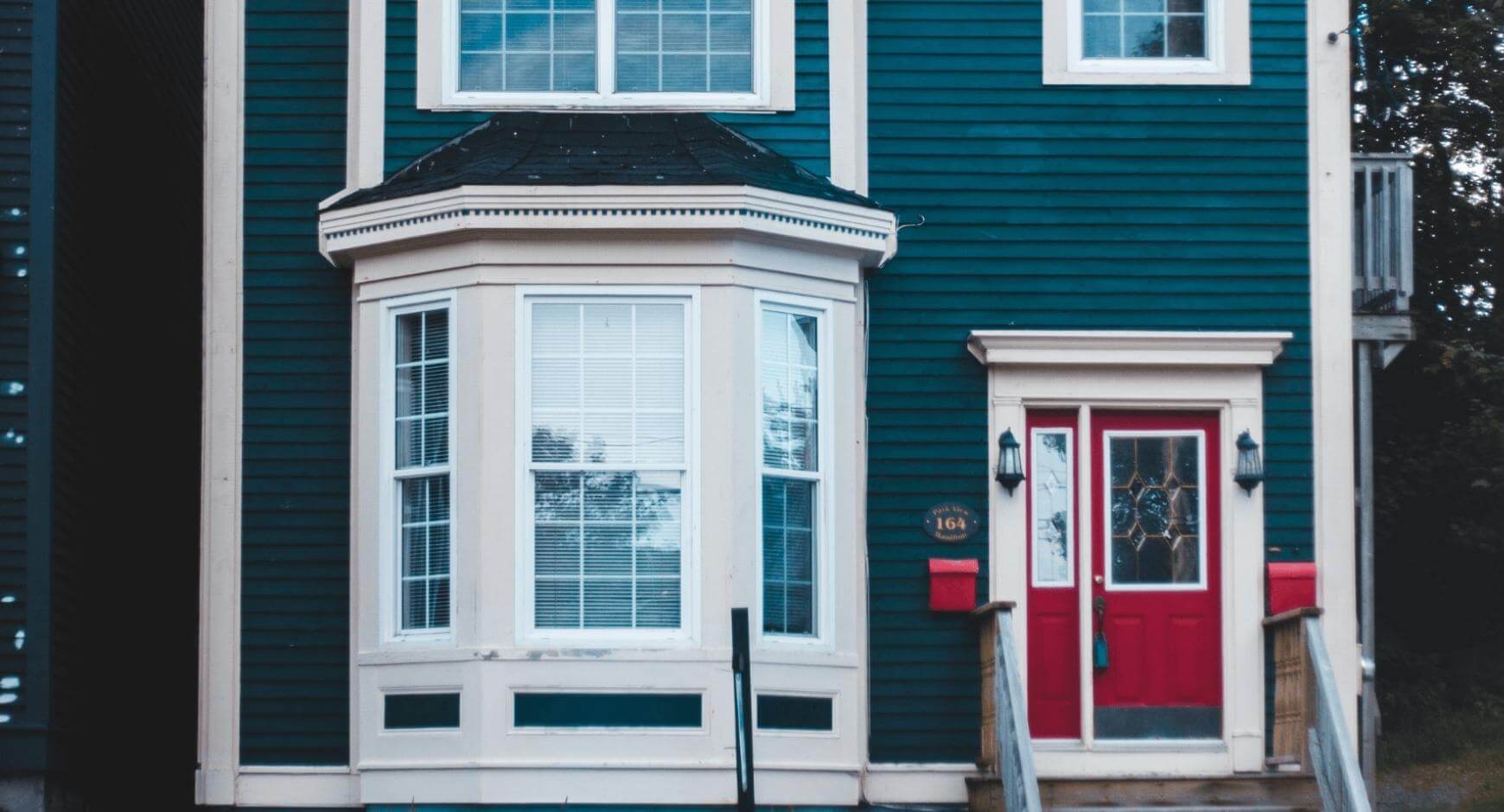 Navy blue house with bright red door