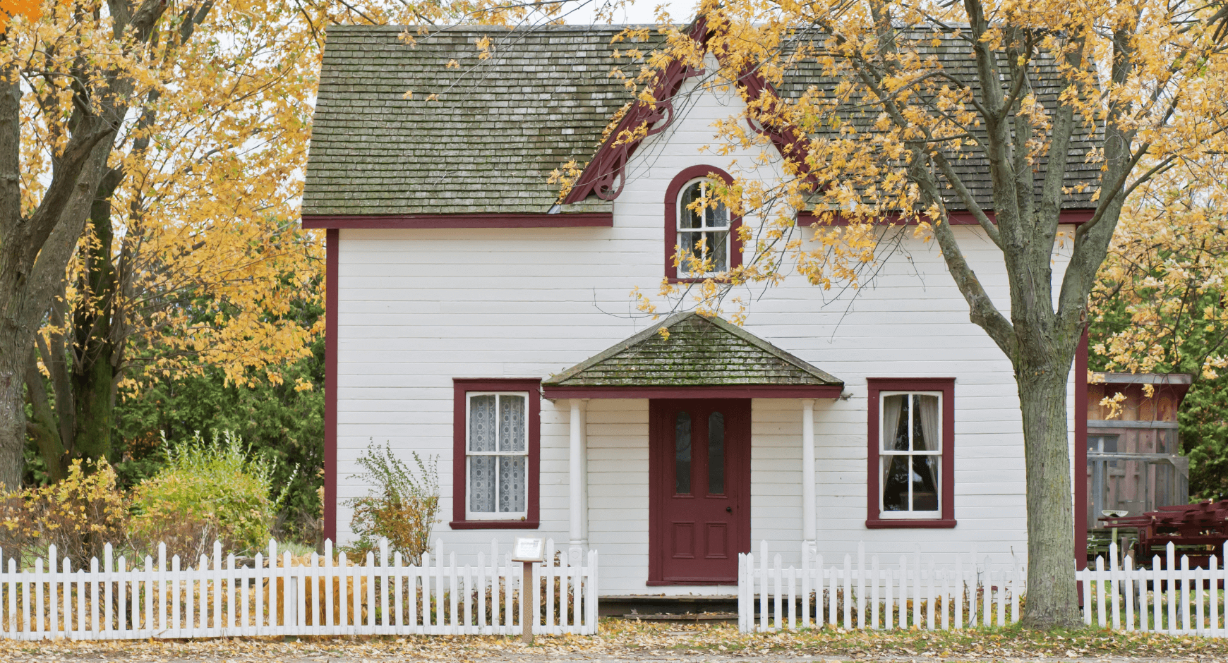 Image of a white house with bold maroon trim