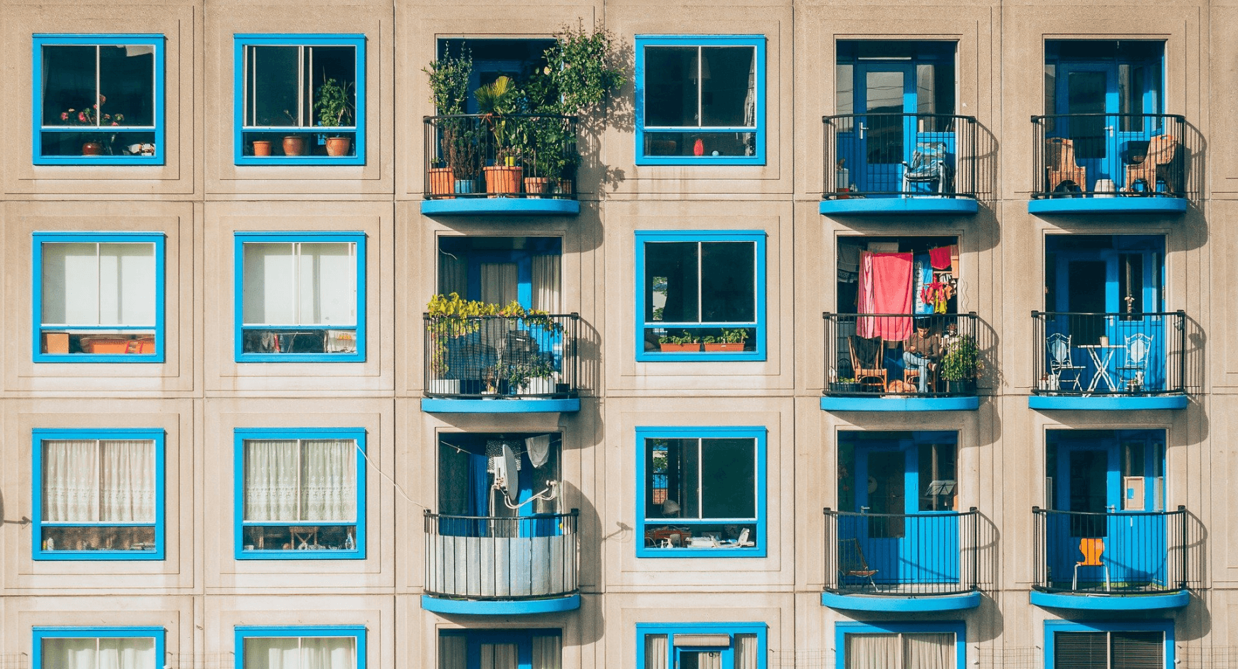Image of an apartment building with fun, colorful exterior window trim