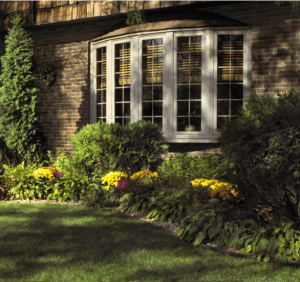 View of a bow window on a brick house from outside