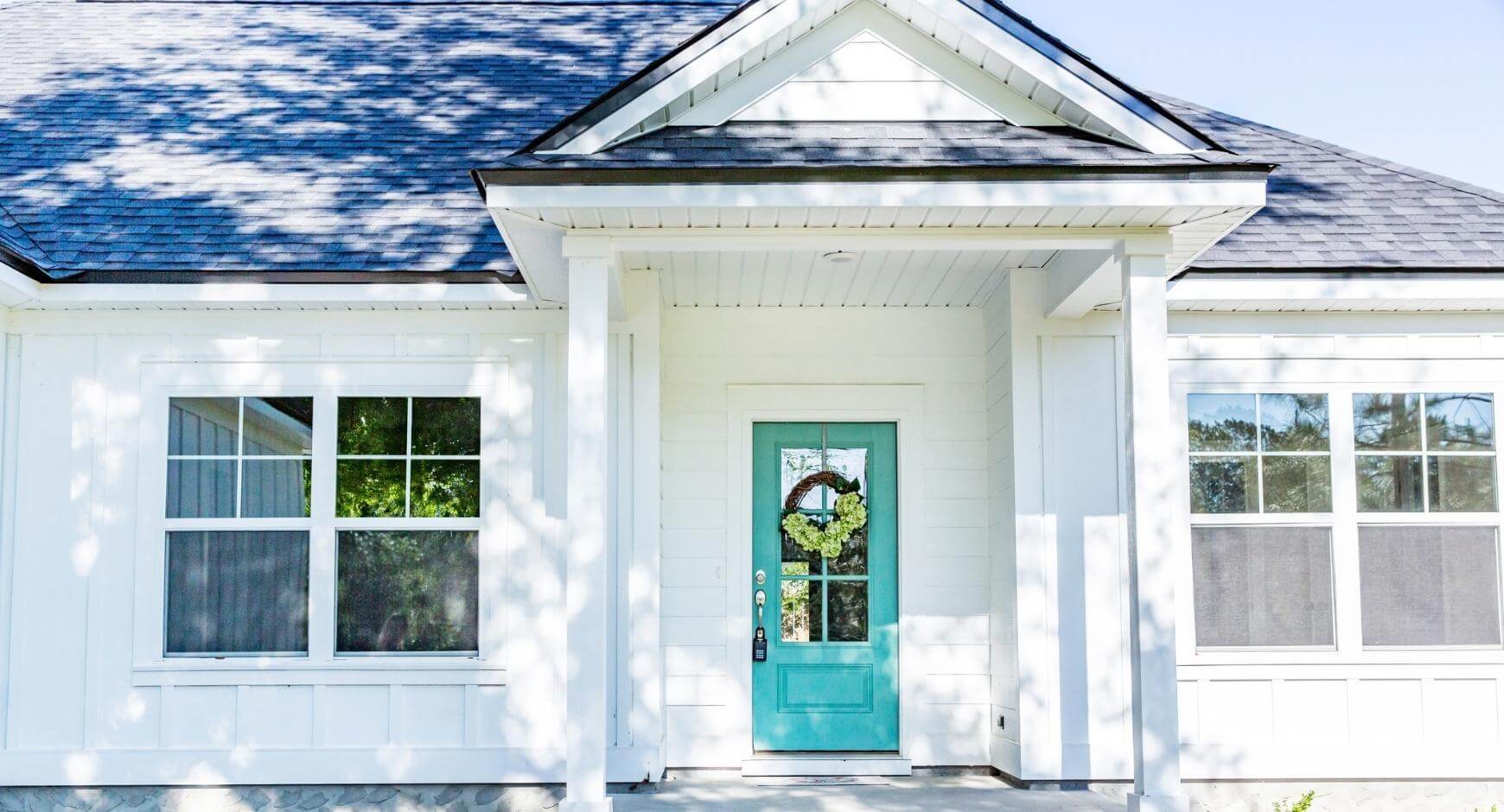 White home with bright blue front door