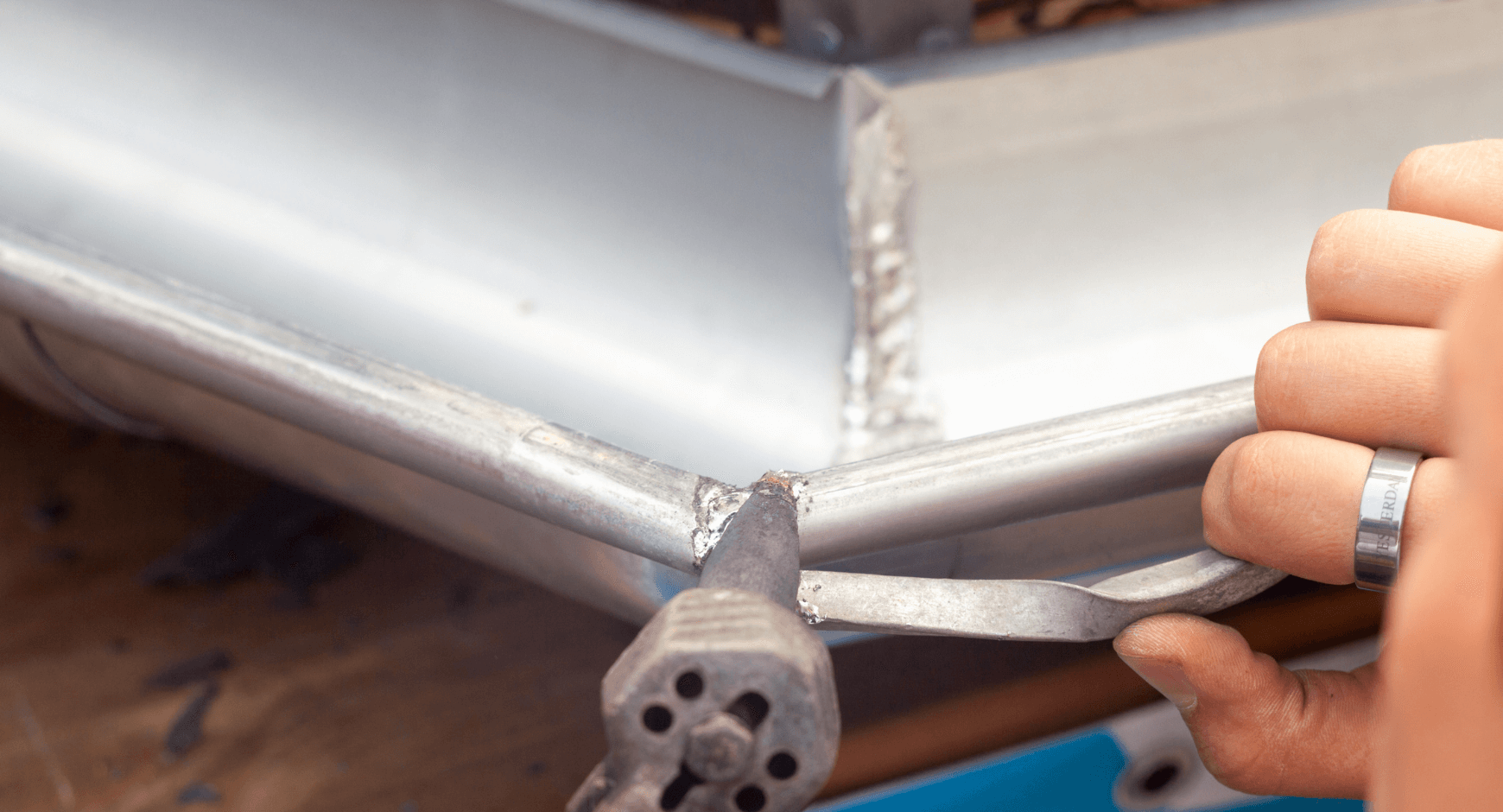 image of an individual repairing a hole in their gutter