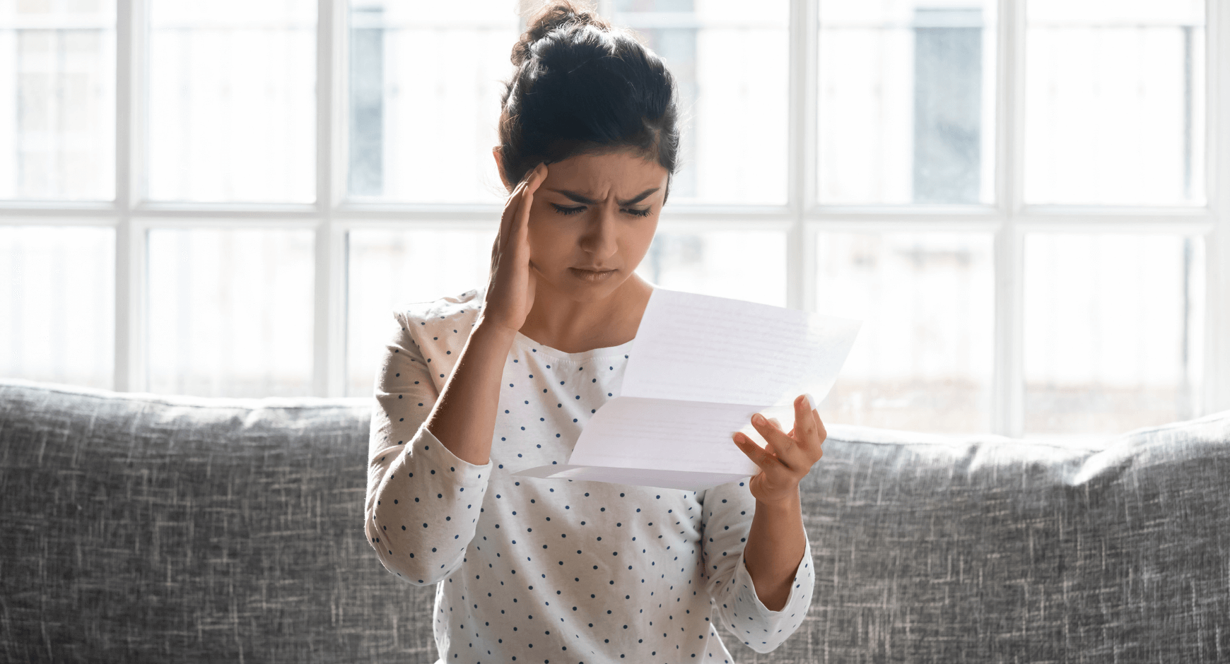 Image of a woman frustrated with her high utility bill