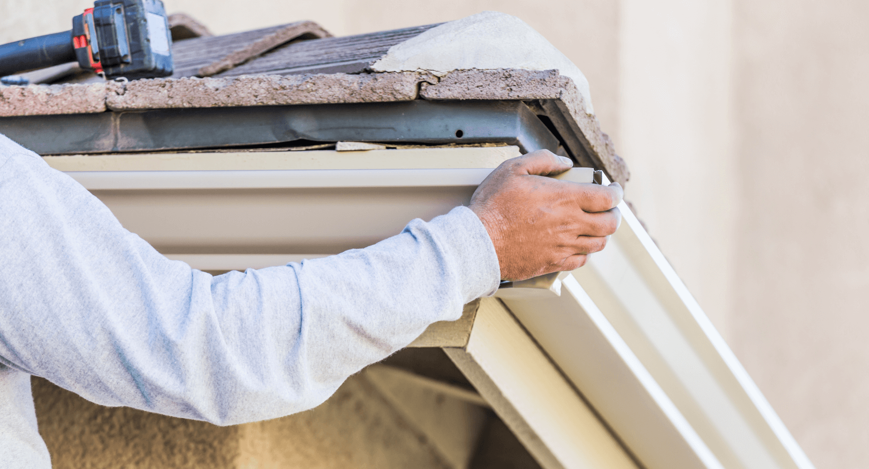 man rehanging gutters