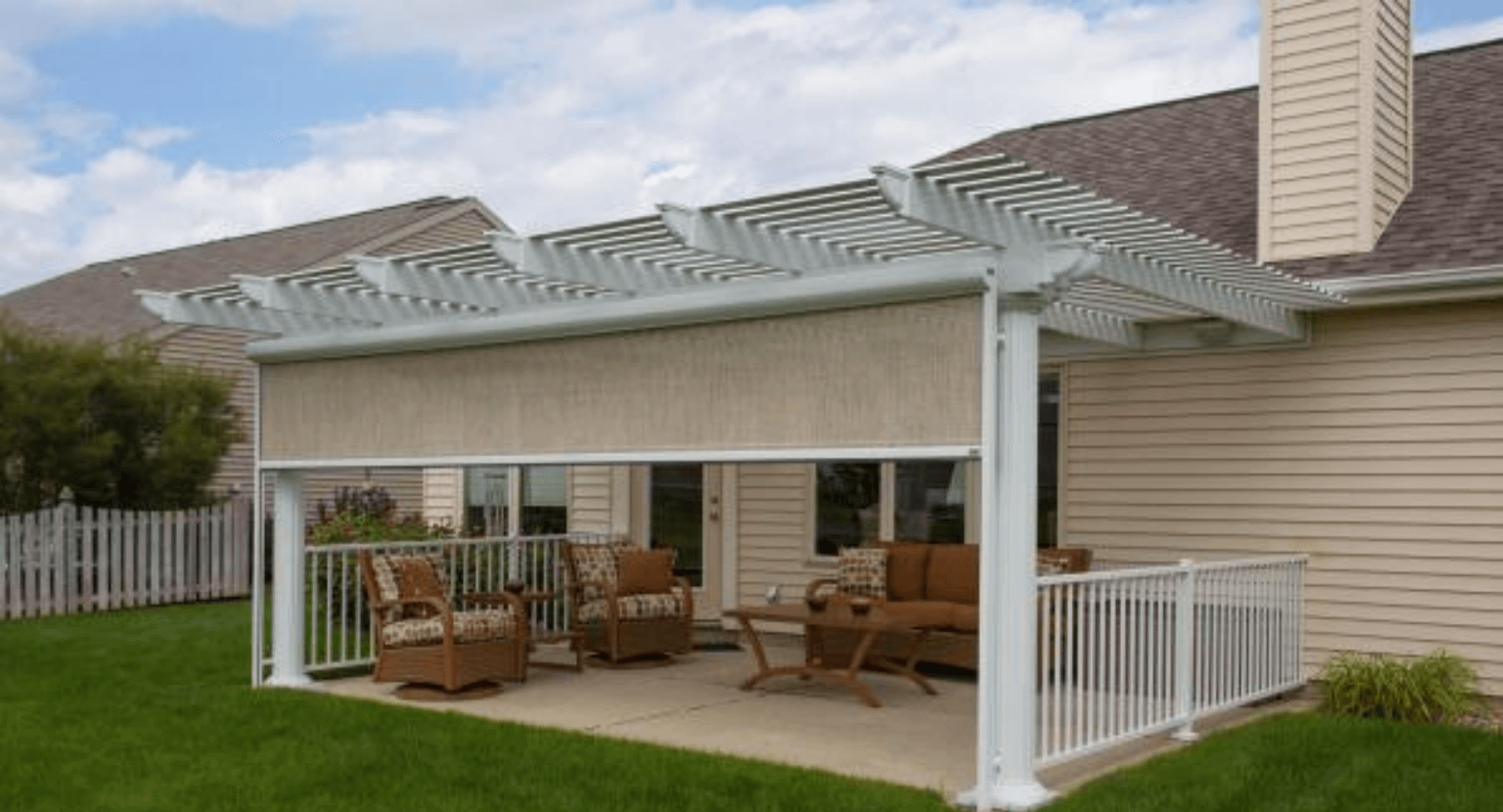 White pergola with a tan sun-roll solar screen