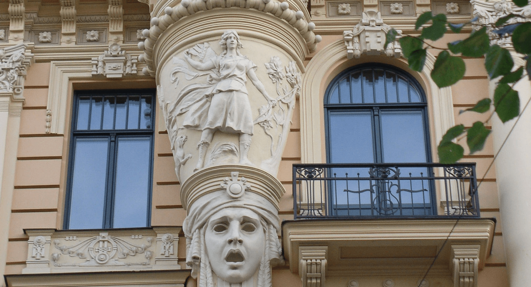 Image of an older building with stucco style window trim