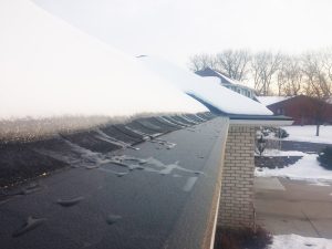 Asher's Helmet Heat melting snow off the roof of a house