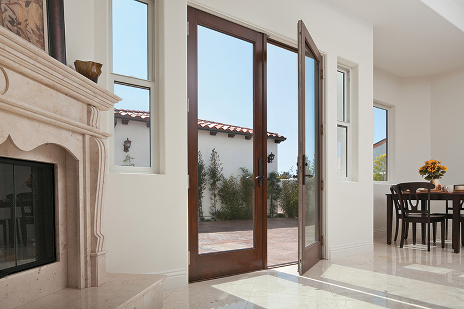 100 Series Single-Hung Windows, Picture Windows and Frenchwood Hinged Patio Door - Inswing with a Pine Interior. 
Spanish Colonial Home Style