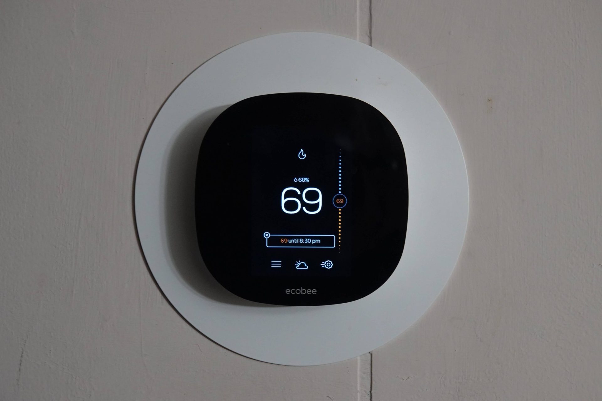 a smart thermostat reading the temperature of the room