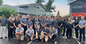 the Asher Lasting Exteriors team standing in front of their office