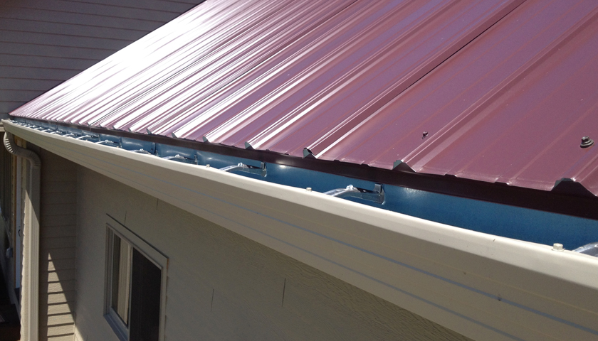 a red roof with a seamless gutter system