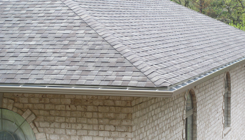 A corner of a roof with a seamless gutter system