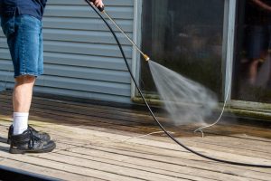 someone power washing their back patio in the spring