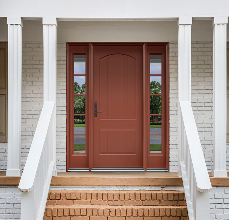 The front exterior entrance of a newly aqua blue painted front door on a white brick ranch style house with brick steps.