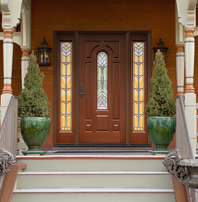 Modern red house and porch. Green shrubs in green vases outside.