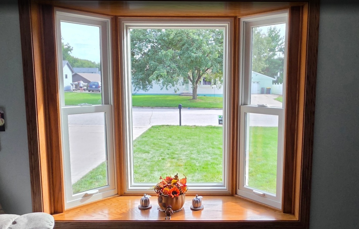 new bay window with wooden trim installed on holmen home